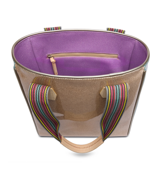 Consuela Emery Classic Tote bag with shiny bronze exterior and colorful striped handles, open top showing purple interior pocket