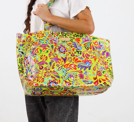 Consuela Limon Jumbo Bag with colorful floral and abstract pattern held by a person