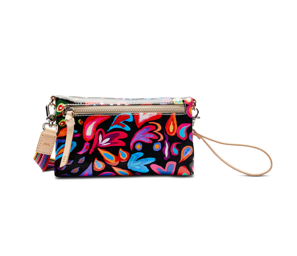 Consuela Sophie Crossbody Bag with colorful floral pattern and wrist strap for easy carrying