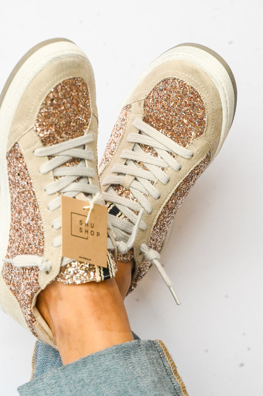 Paz Champagne Shu Shop Sneakers featuring glitter accents and white laces with suede details