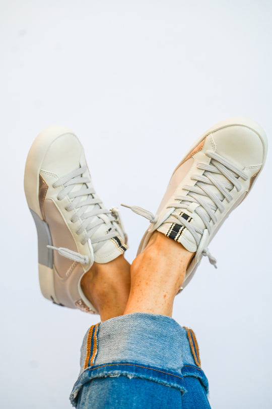 Ruby Mushroom Shu Shop sneakers in white worn with blue jeans showing lace-up design and casual style
