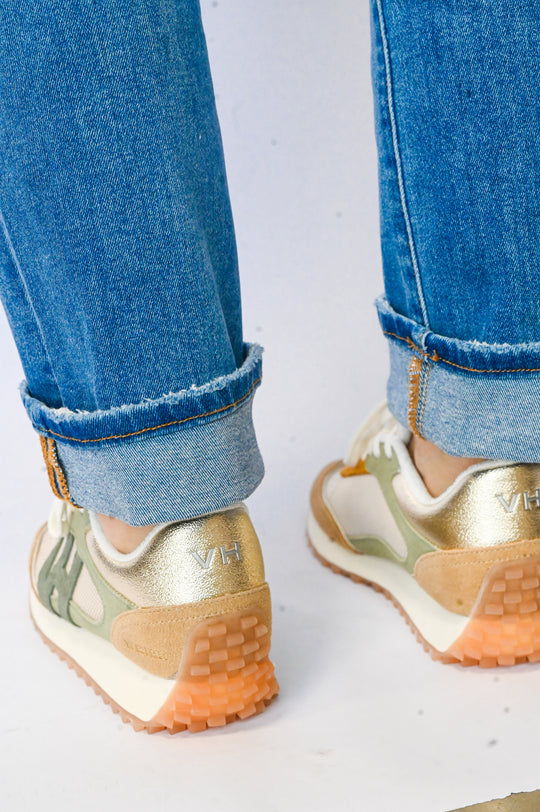 Vintage Havana sneakers in gold and beige with gum soles worn with rolled blue jeans