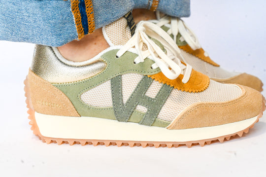 Vintage Havana sneakers in beige, green, and gold with suede and mesh details worn with denim jeans