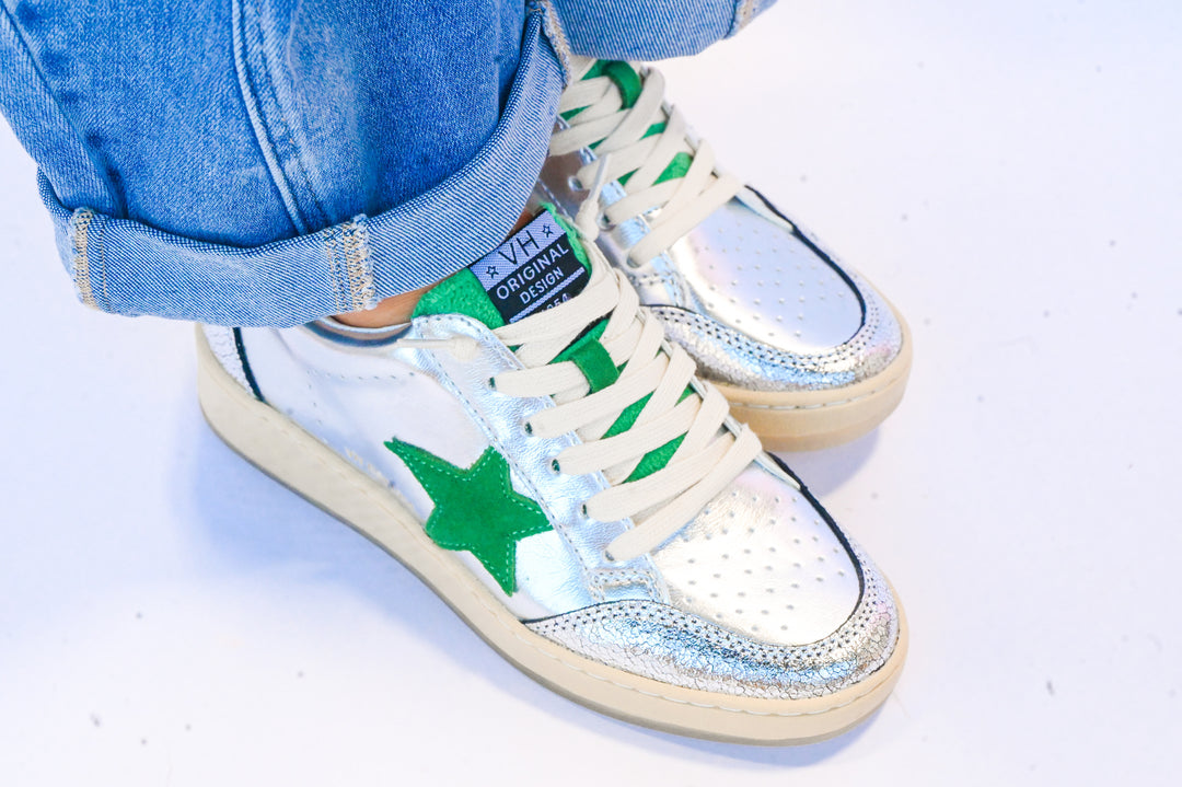 Silver and green Vintage Havana sneakers with star detail worn with cuffed blue jeans