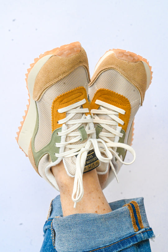 Lightweight Vintage Havana sneakers with beige, green, and orange accents worn with blue jeans