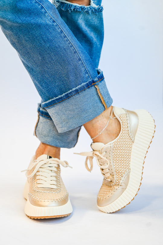 ShuShop gold sneaker fashion with woven texture and thick white soles paired with rolled-up blue jeans