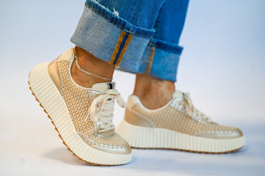 ShuShop gold sneaker fashion with textured design and thick white sole worn with rolled-up jeans